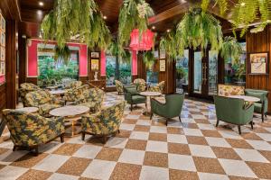 a restaurant with tables and chairs and a checkered floor at MAYFAIR Lake Resort in Raipur