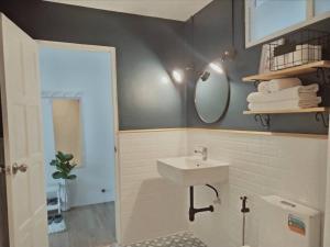 a bathroom with a sink and a mirror at Thira House in Karon Beach +32 photos
