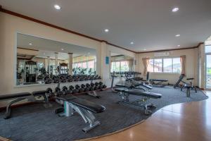 a gym with a lot of treadmills and machines at Pimann Inn Hotel in Chiang Rai