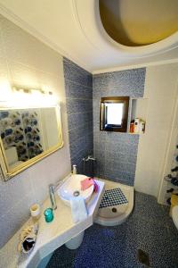 a bathroom with a sink and a toilet at Apartment Vana in Metamorfosi +45 photos