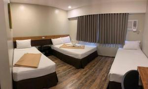 Voodi või voodid majutusasutuse Cebu R Hotel Capitol toas