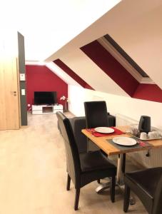 a dining room with a table and black chairs at SeMiHoMe in Dietingen