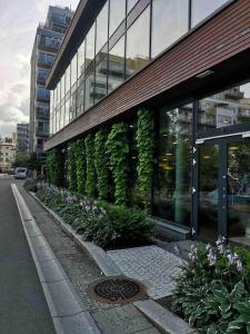 a building with plants on the side of it at CITY CENTER OSLO BLACK AND WHITE APARTMENT in Oslo
