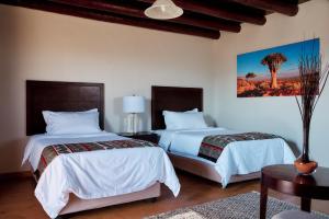 A bed or beds in a room at Agama Lodge