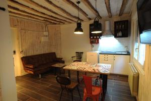 a kitchen and living room with a couch and a table at Lombera Apartamentos in Arnedillo