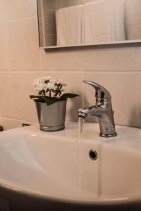 a bathroom sink with a vase of flowers on it at Mohlos house with Seaview in Mochlos