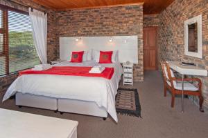 a bedroom with a large bed in a brick wall at White Shark Guest House in Gansbaai