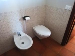 a bathroom with a white toilet and a sink at Dammuso Surya Cloe in Pantelleria