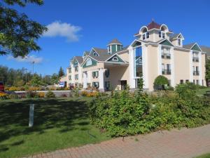 a large white building with a turret at Bayside Hotel of Mackinac in Mackinaw City
