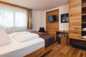 Postel nebo postele na pokoji v ubytování Hotel Post