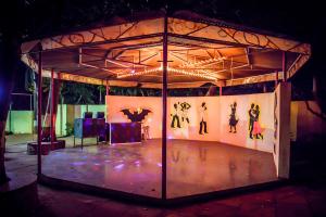 a stage with a person dancing on a stage at Adamo The Village in Matheran