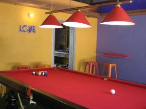 a pool table in a room with two lights at Pink Flamingo Resort in Port Douglas