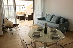 a living room with a table and a couch at Brilliant 2BDR Apartment in Poris de Abona