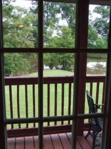 a view from a window of a porch with a chair at Susan's Cottages in Alexandria