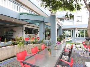 a table and chairs in front of a building at The Lilly Hotel in Chiang Mai