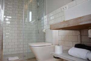 a white bathroom with a toilet and a shower at YOU & CO. Saler Beach Boutique in Valencia