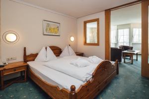 Postel nebo postele na pokoji v ubytování Hotel Post