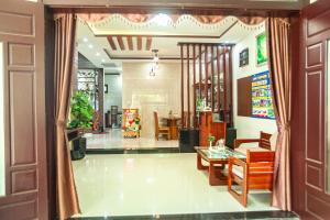 a room with a table and chairs and a dining room at Golden Soulmate homestay in Hoi An
