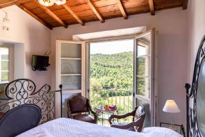 a bedroom with a bed and a large window at Agriturismo La Mignola in Quercianella