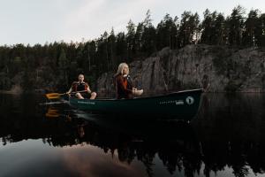 two people are sitting on a boat in the water at Lapland Hotels Bulevardi in Helsinki