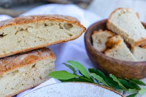 a plate with a loaf of bread and a bowl of bread at Agriturismo La Mignola in Quercianella