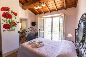 a bedroom with a bed with shoes on it at Agriturismo La Mignola in Quercianella
