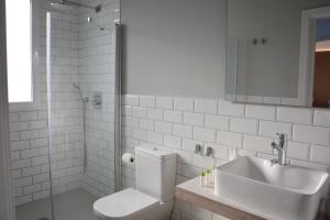 a bathroom with a sink and a toilet and a shower at YOU & CO. Saler Beach Boutique in Valencia