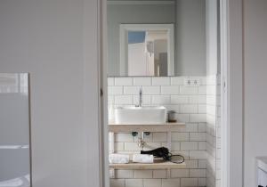 a bathroom with a sink and a mirror at YOU & CO. Saler Beach Boutique in Valencia