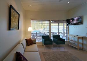 a living room with a couch and chairs and a table at Rukariutta Apartments in Ruka