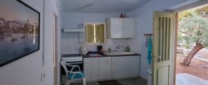 a small kitchen with a sink and a counter at VILA INSPIRATION - ON KINI BEACH in Kinion