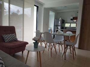 拉特瓦伊達的住宿－Quindio - Apartasol 207，厨房以及带桌椅的起居室。