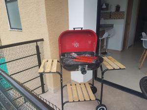 a red suitcase sitting on a table next to two benches at Quindio - Apartasol 207 in La Tebaida