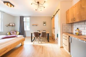 a kitchen and living room with a table and chairs at Design Apartments - "Das Kutscherhaus" in Potsdam