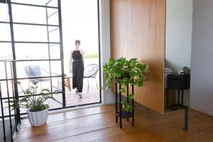 a woman walking through a room with a window at Casa Nican by Barrio Mexico in Guadalajara