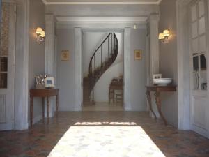 a hallway with a spiral staircase in a house at Manoir des Tuileries du Buisson in Verneuil d'Avre et d'Iton