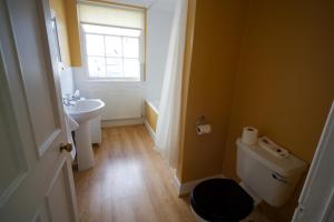 
a bathroom with a toilet, sink, and tub at The Creggans Inn in Strachur
