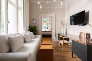 a living room with a white couch and a table at Monsieur Didot in Athens