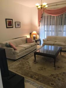 a living room with a couch and a coffee table at Nice Furnished apartment in Amman