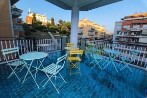 a group of tables and chairs on a balcony at O.Effe. Suites / Vatican in Rome