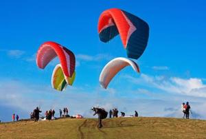 a group of people flying kites on a hill at BillingVista Guest House Bir in Bīr