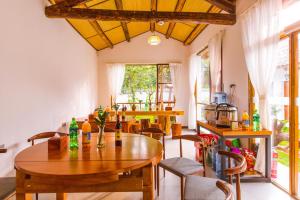 a dining room with wooden tables and chairs at Swallow Nest Guesthouse in Kunming