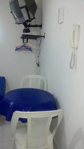 a room with a table and a tv and a phone at Sonhos de sereia in Ponta da Fruta