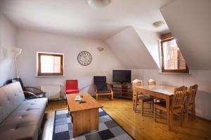 a living room with a couch and a table at Spacious 2-bedroom apartment Zabjak with AC Tour As Ljubljana in Ljubljana