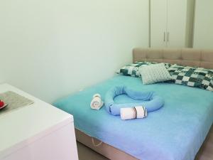 a childs bed with a pillow shaped like a dog at Apartment GEA 18 in Novi Sad