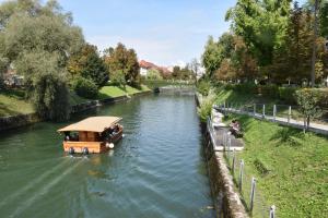 een boot met een dak op een rivier bij Apartments Old Town in Ljubljana