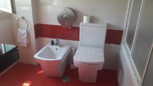 a small bathroom with a toilet and a sink at Hotel Alicante in Lisbon