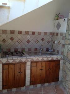 a kitchen with a sink and a stove at VILLA BUTTERFLY 1 e 2 sea and history in Capaci