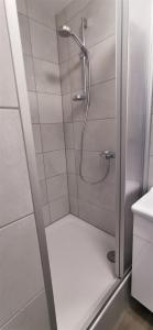 a shower with a glass door in a bathroom at Apartment außen Pfui innen Hui in Mönchengladbach +30 photos