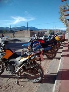 a row of motorcycles parked on the side of a street at Sumaq Samay in San Antonio de los Cobres