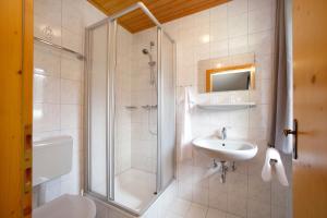 a bathroom with a shower and a sink and a toilet at Chalet Kirsten in Zell am See +13 photos